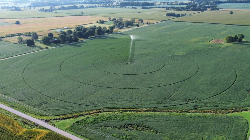 Overhead view of center pivot irrigation in soybean field